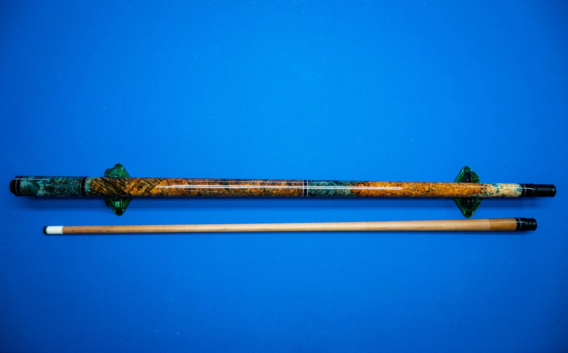 Full view of the handcrafted Coral pool cue featuring blue resin stabilized amboyna burl